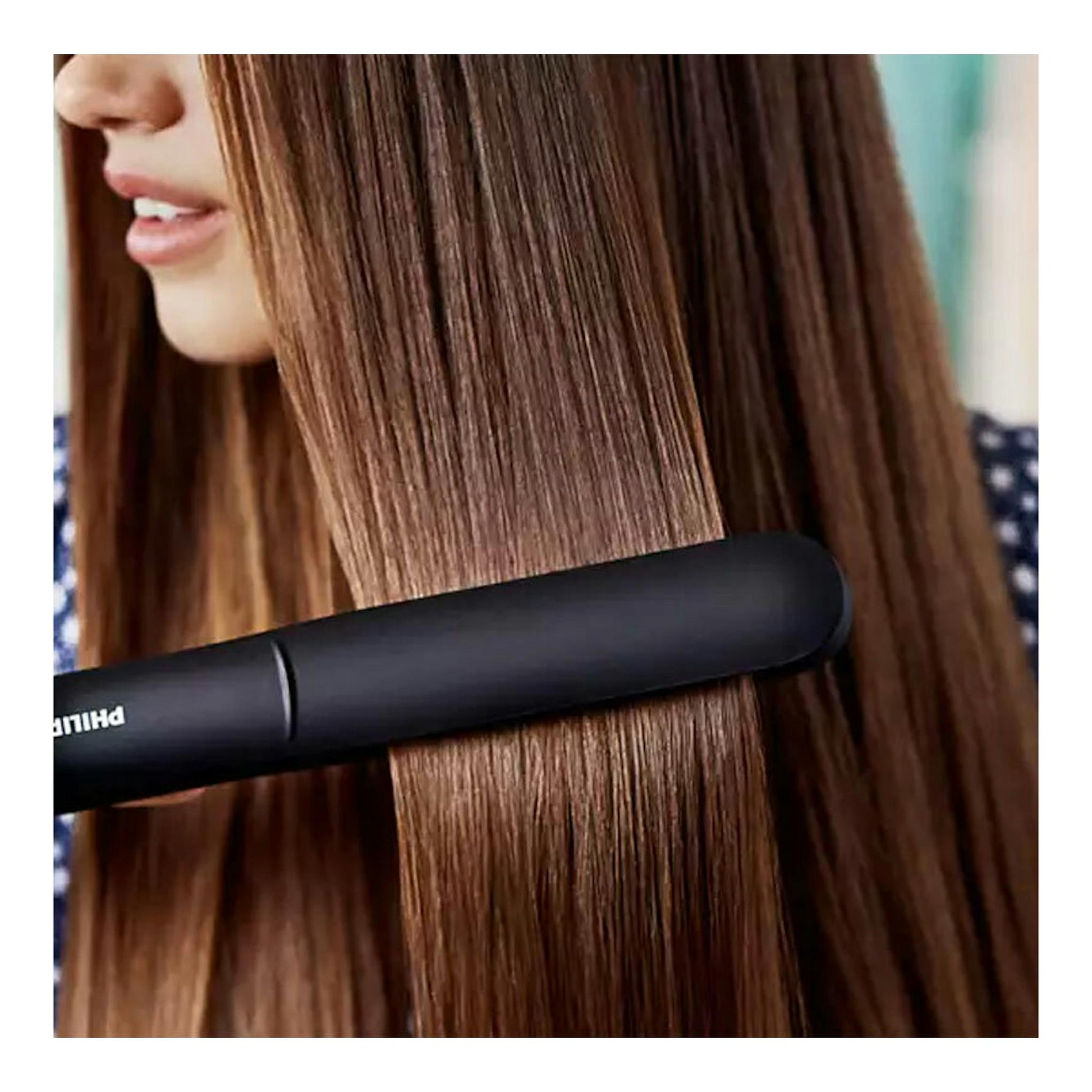 Plancha de pelo Philips BHS378/00 negra en primer plano alisando cabello marrón.