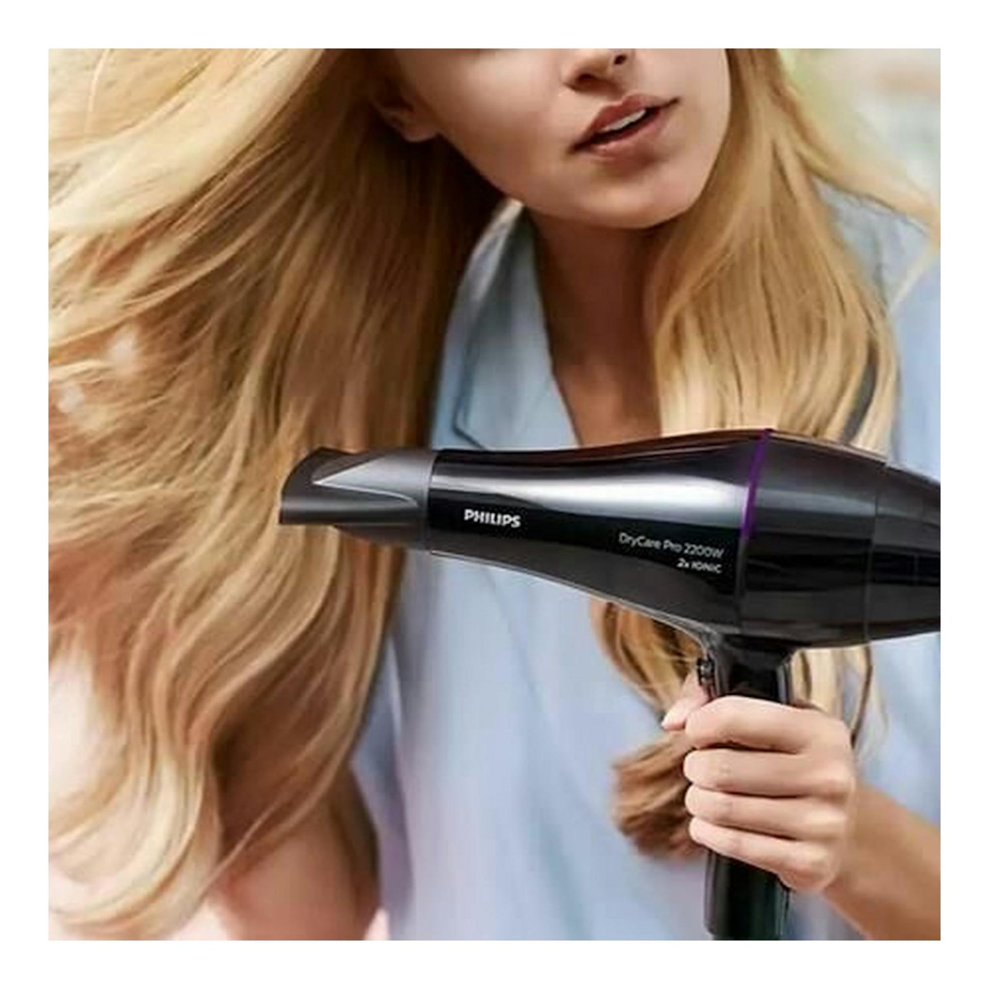 Secador Philips BHD274/00 negro, de perfil, en uso por una mujer rubia.
