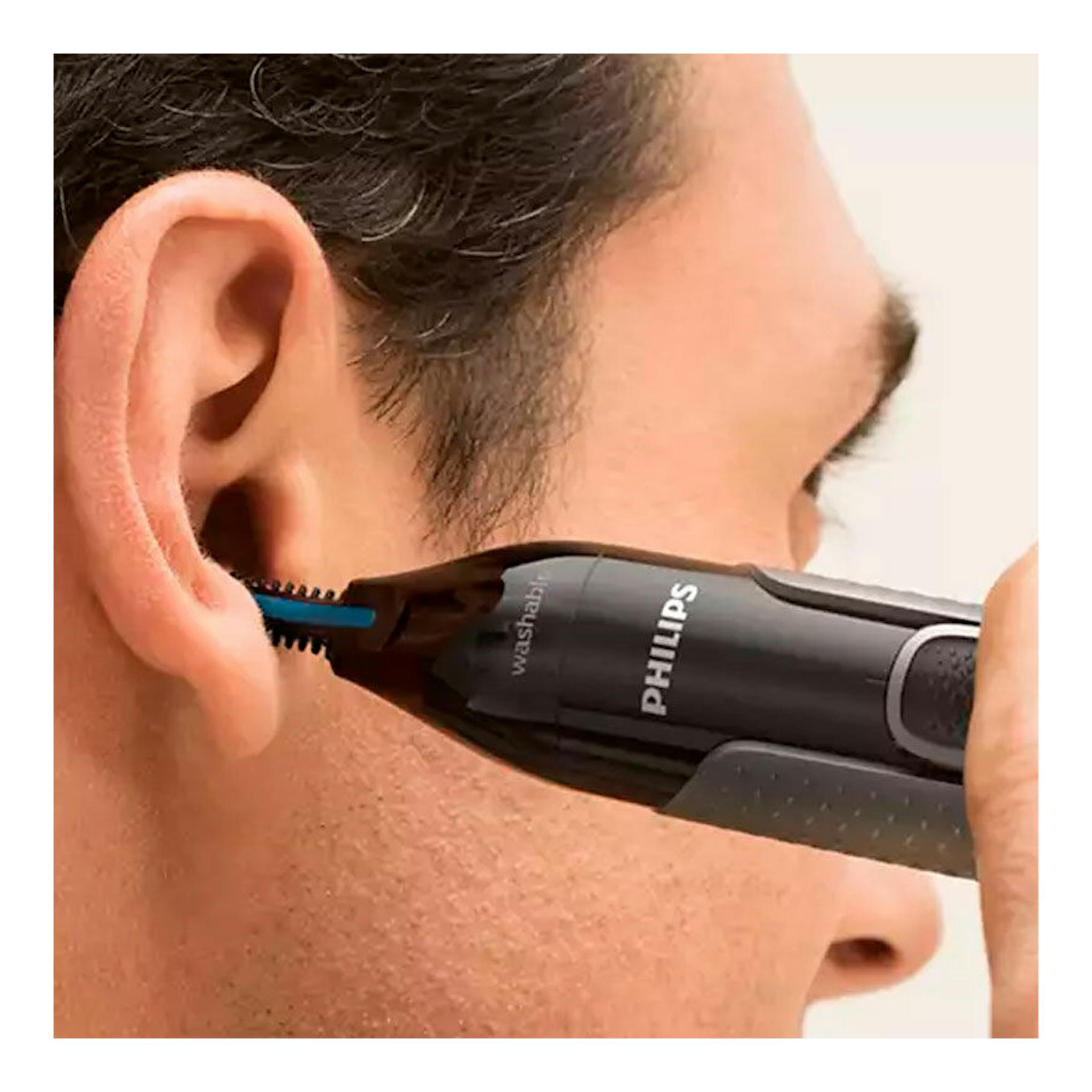 Cortapelo Philips NT3650/16 negro usado junto al oído de un hombre, vista lateral de cerca.