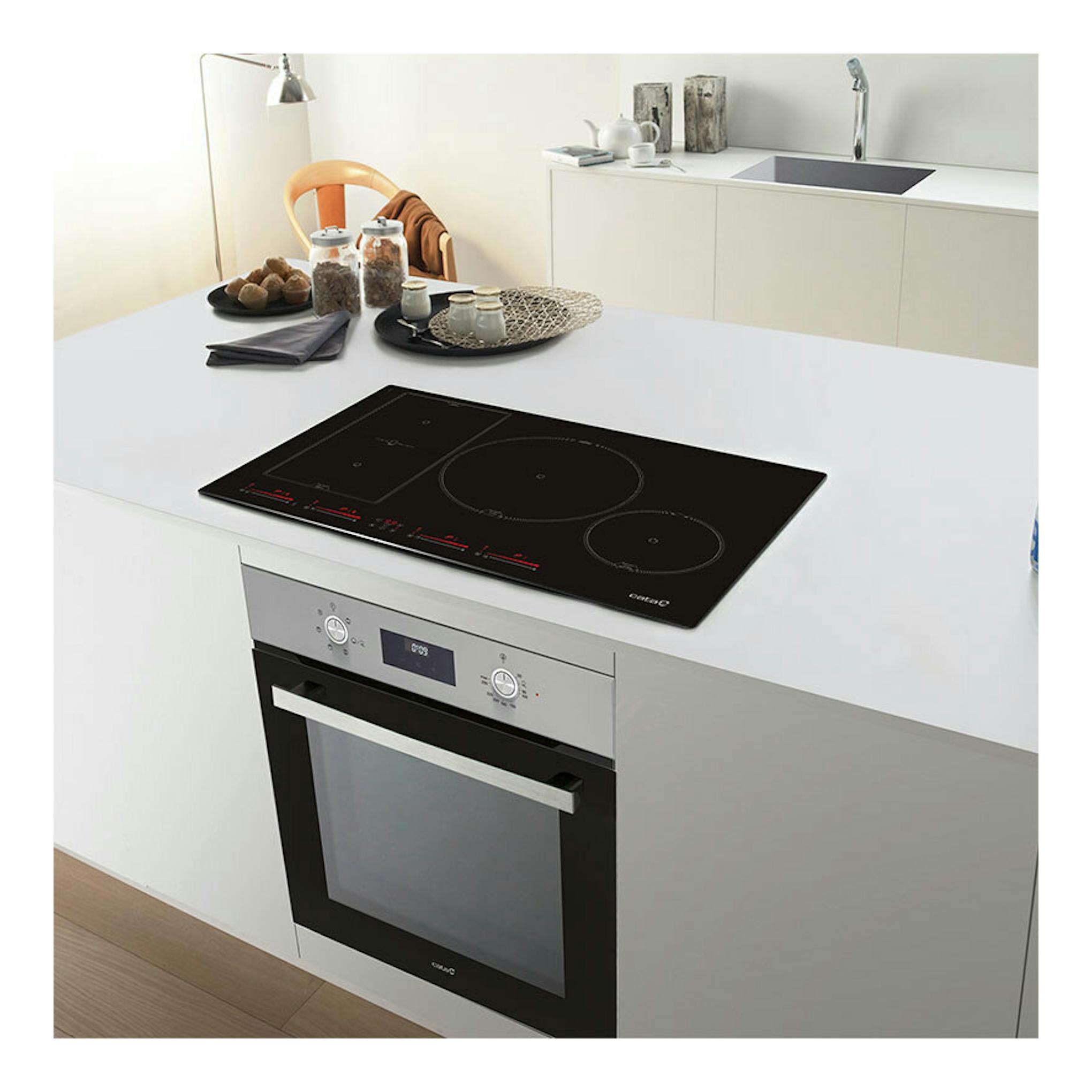 Placa de inducción Cata INSB8021BK/A negra, vista en ángulo sobre encimera blanca de cocina.