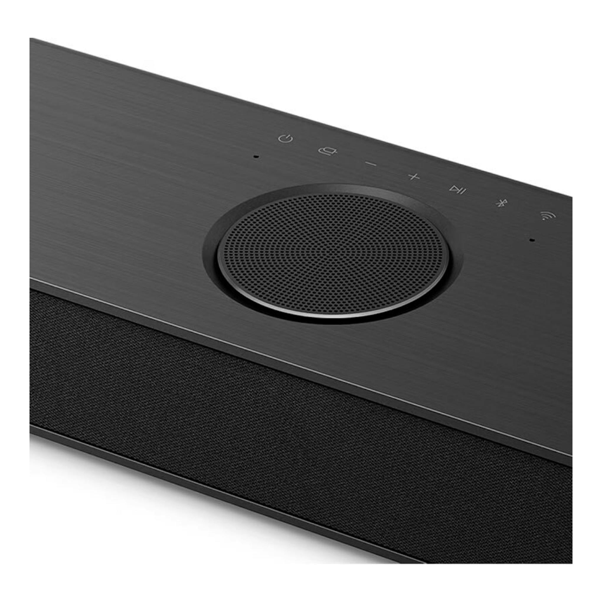 Barra de sonido LG S80TR negra, vista en ángulo superior con rejilla circular y controles táctiles.