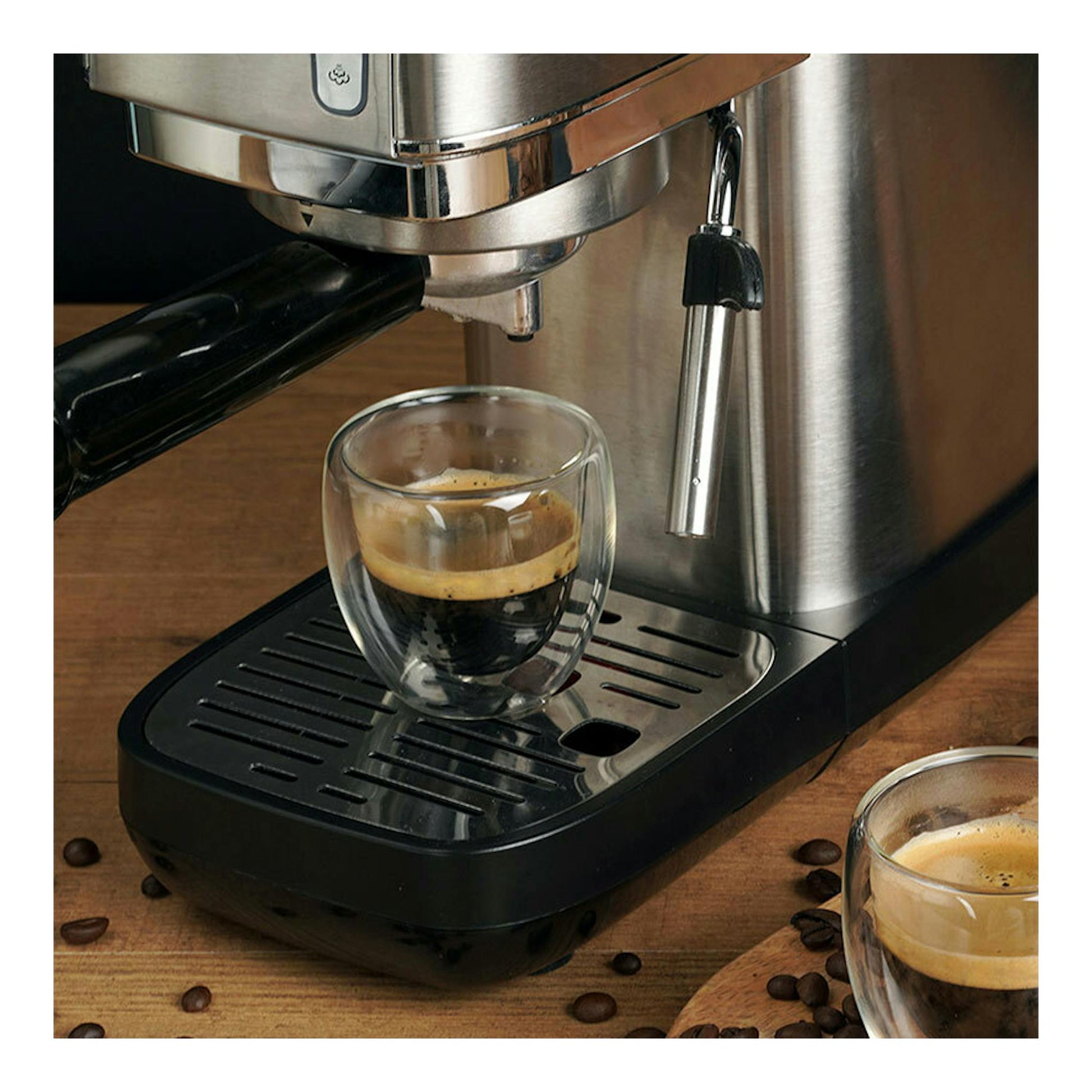 Cafetera espresso Ariete Slim de metal, vista frontal parcial, en acero inoxidable y negro, con taza de café.