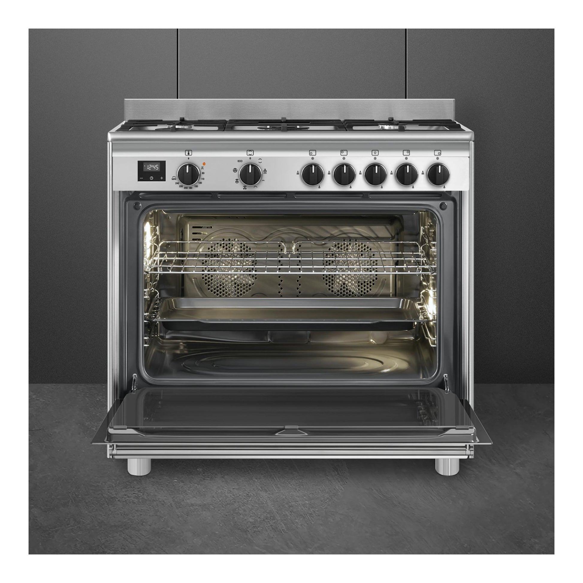 Cocina Smeg BG91X2 de acero inoxidable, vista frontal, con horno abierto y cinco zonas.