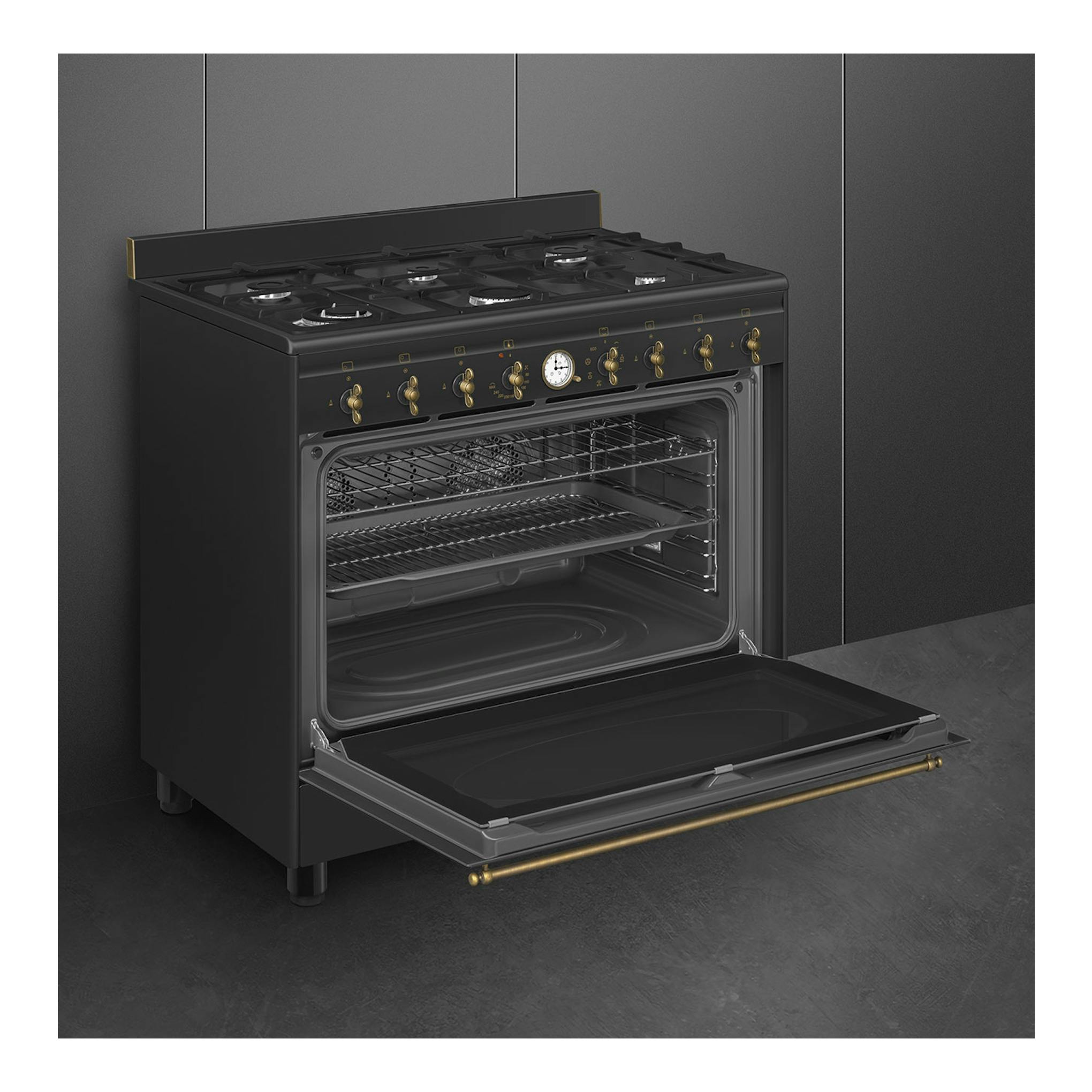 SMEG CO90GMAN2: cocina de gas antracita, vista frontal en ángulo, con horno abierto y mandos dorados.