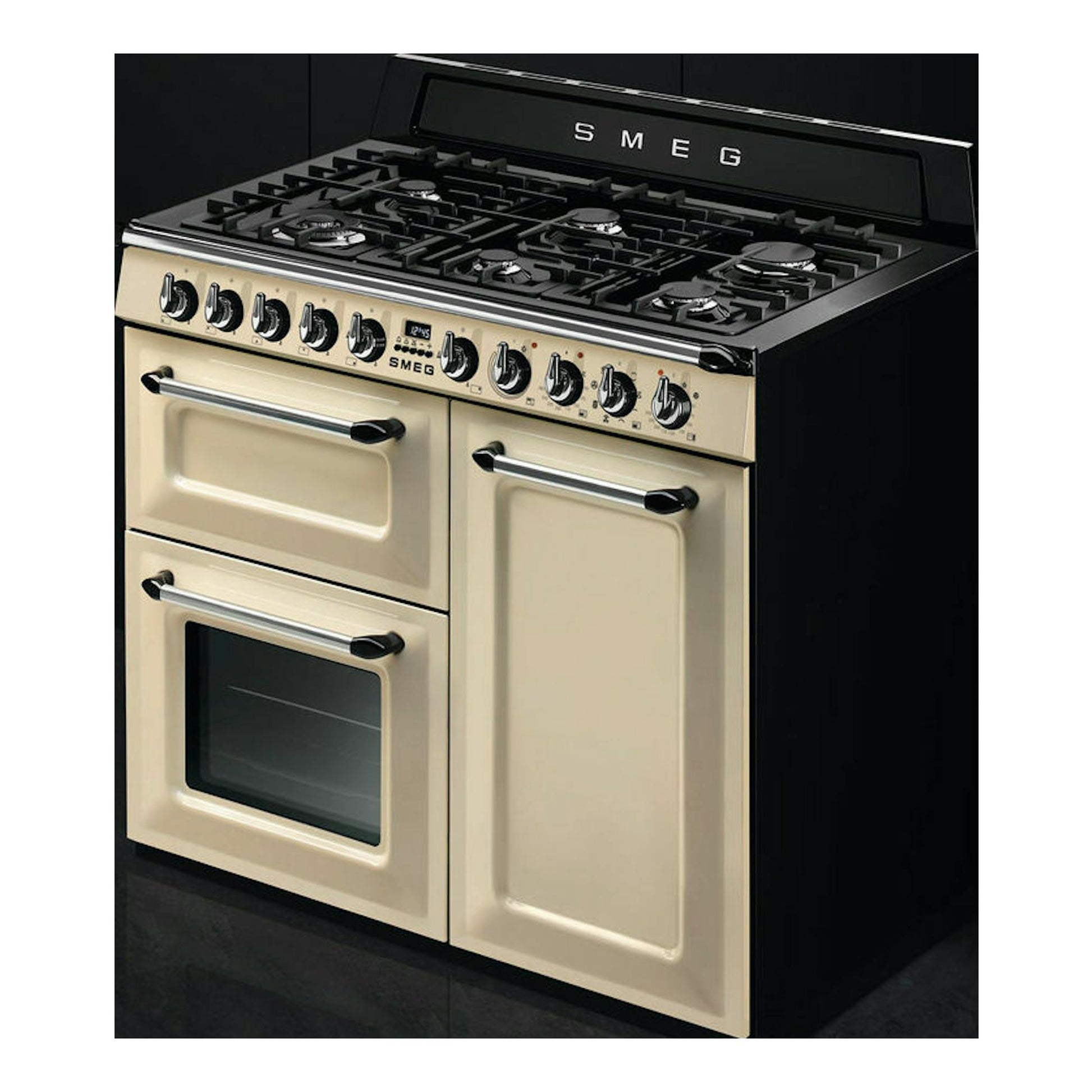 Cocina Smeg TR103P beige, vista frontal en ángulo, con placa de gas negra y dos hornos.