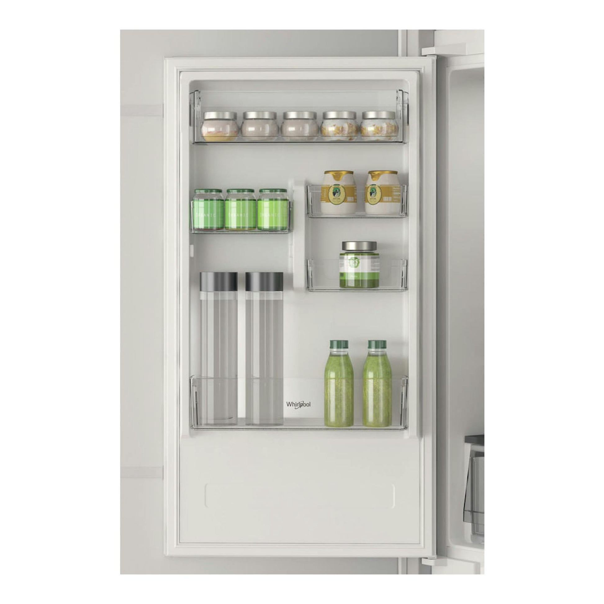 Interior de la puerta de un frigorífico integrable Whirlpool WHC18 T311 blanco, con estantes y botellas.