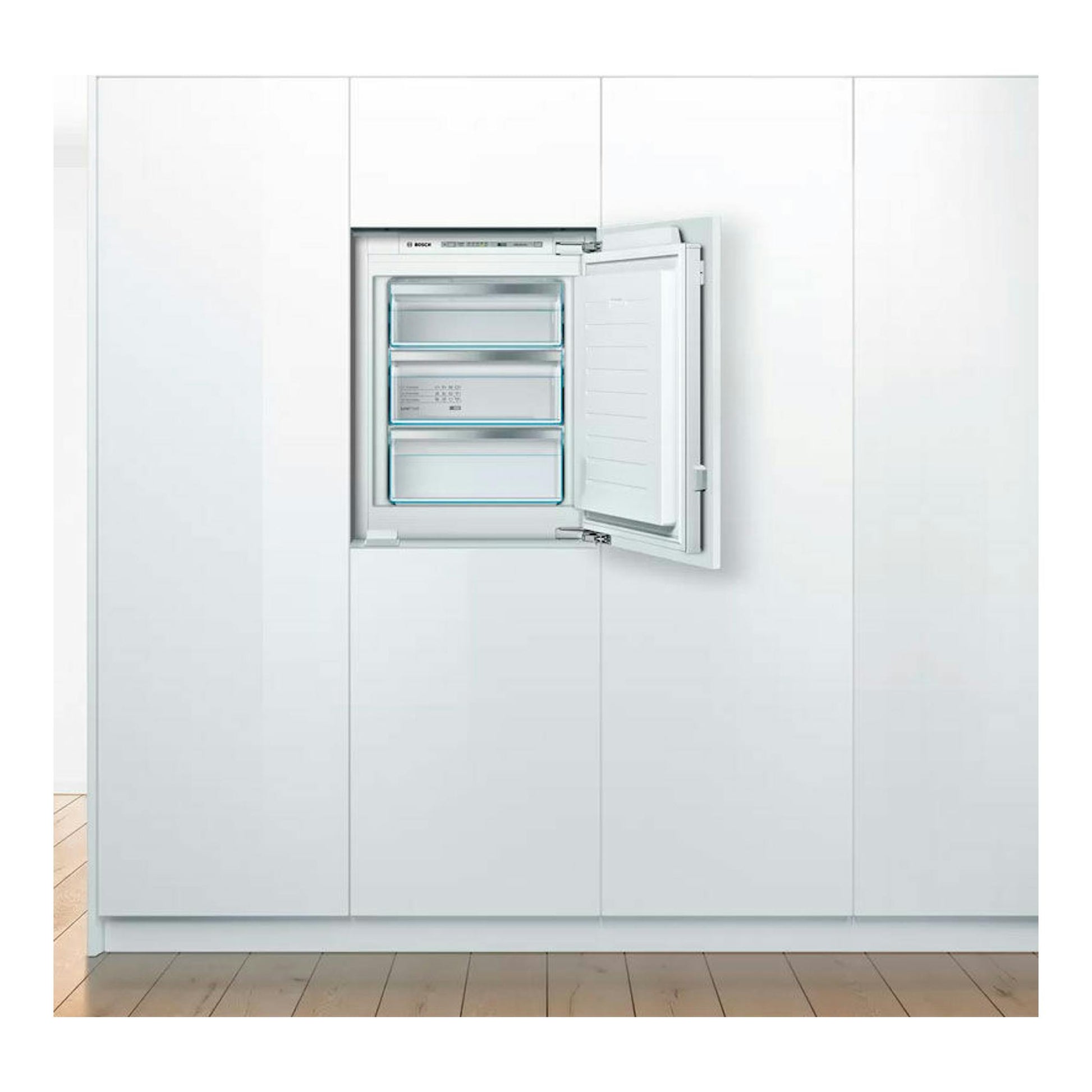 Congelador vertical integrable Bosch GIV11AFE0 blanco, visto de frente con la puerta abierta y tres cajones.
