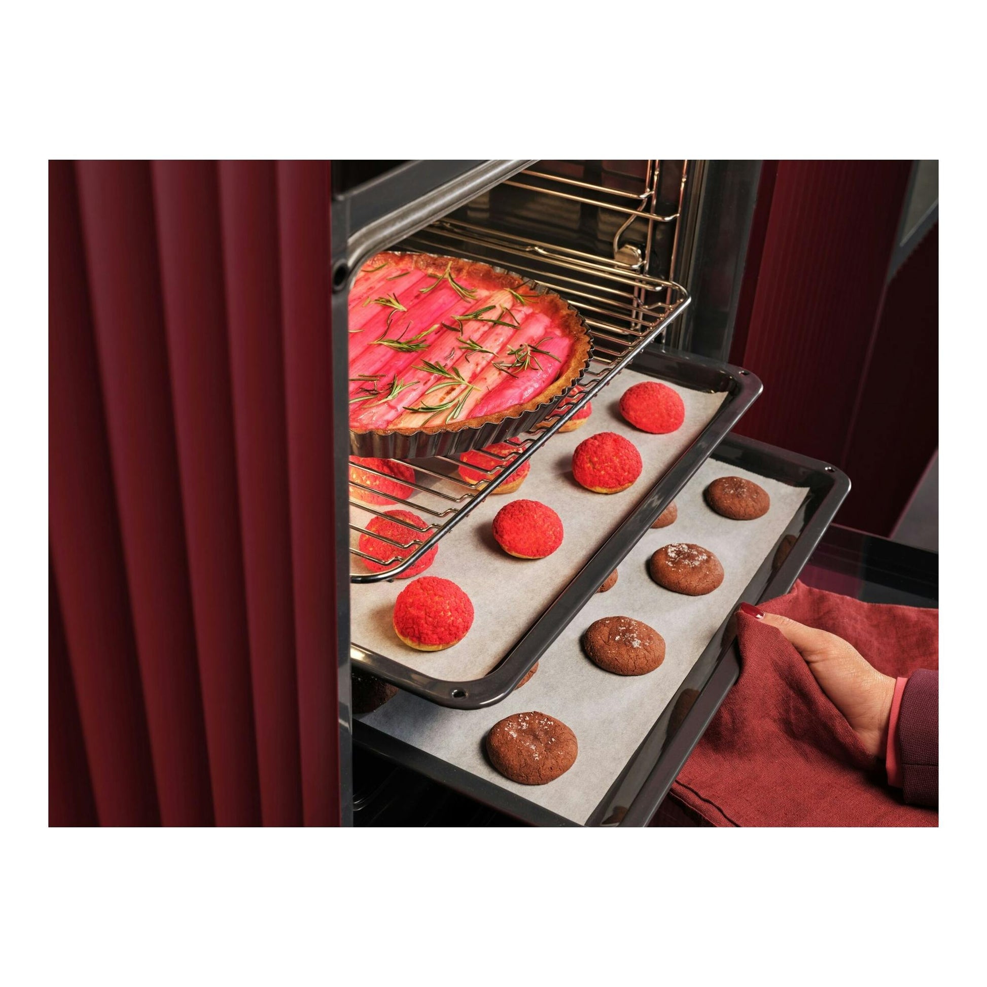 Horno AEG GU5PB43FPM negro, vista interior con bandejas de tartaleta y galletas en horno abierto.
