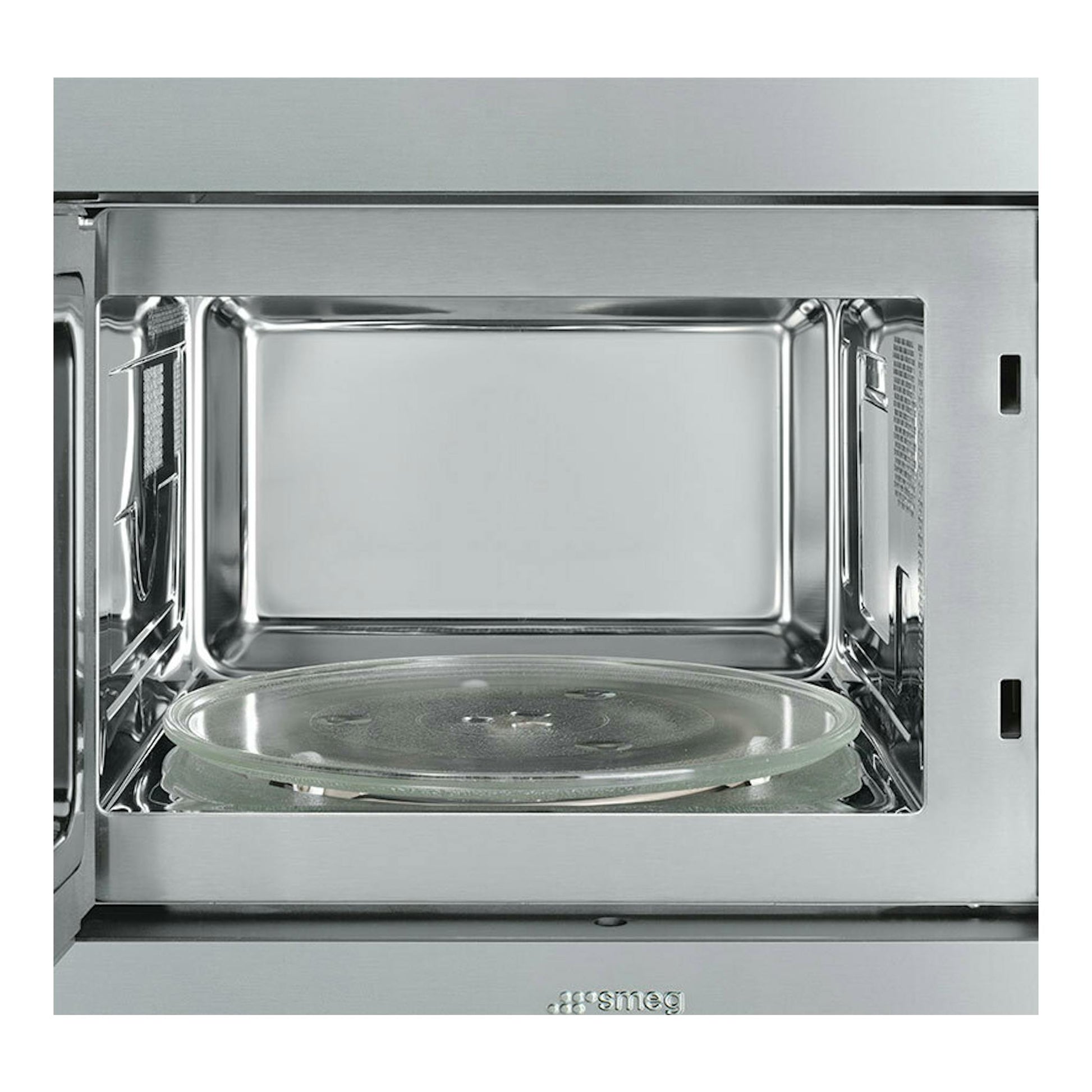 Microondas integrable Smeg FMI325X abierto, interior de acero inoxidable con plato giratorio de vidrio.
