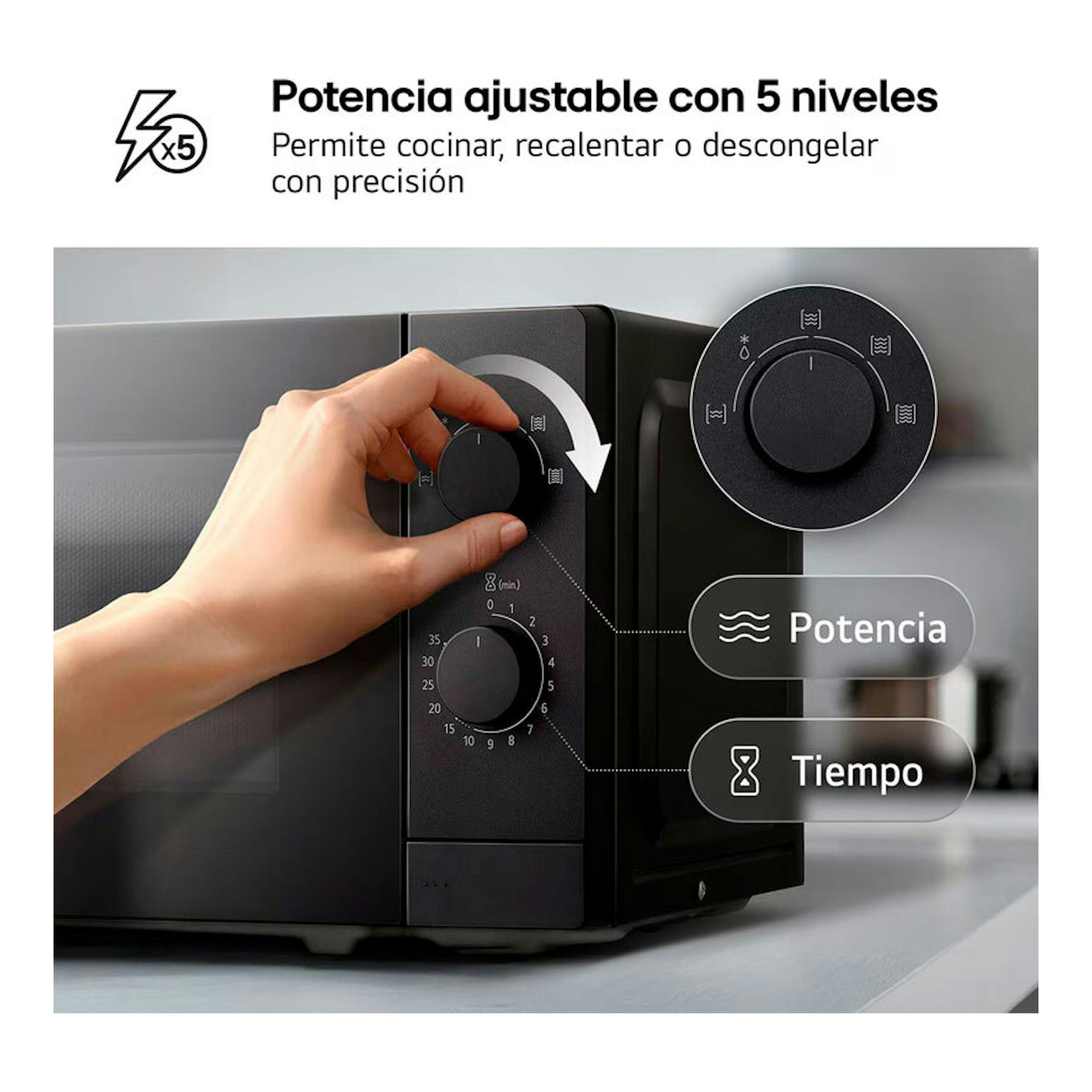 Microondas LG MS2082F negro, vista frontal en ángulo, con una mano ajustando el selector de potencia.