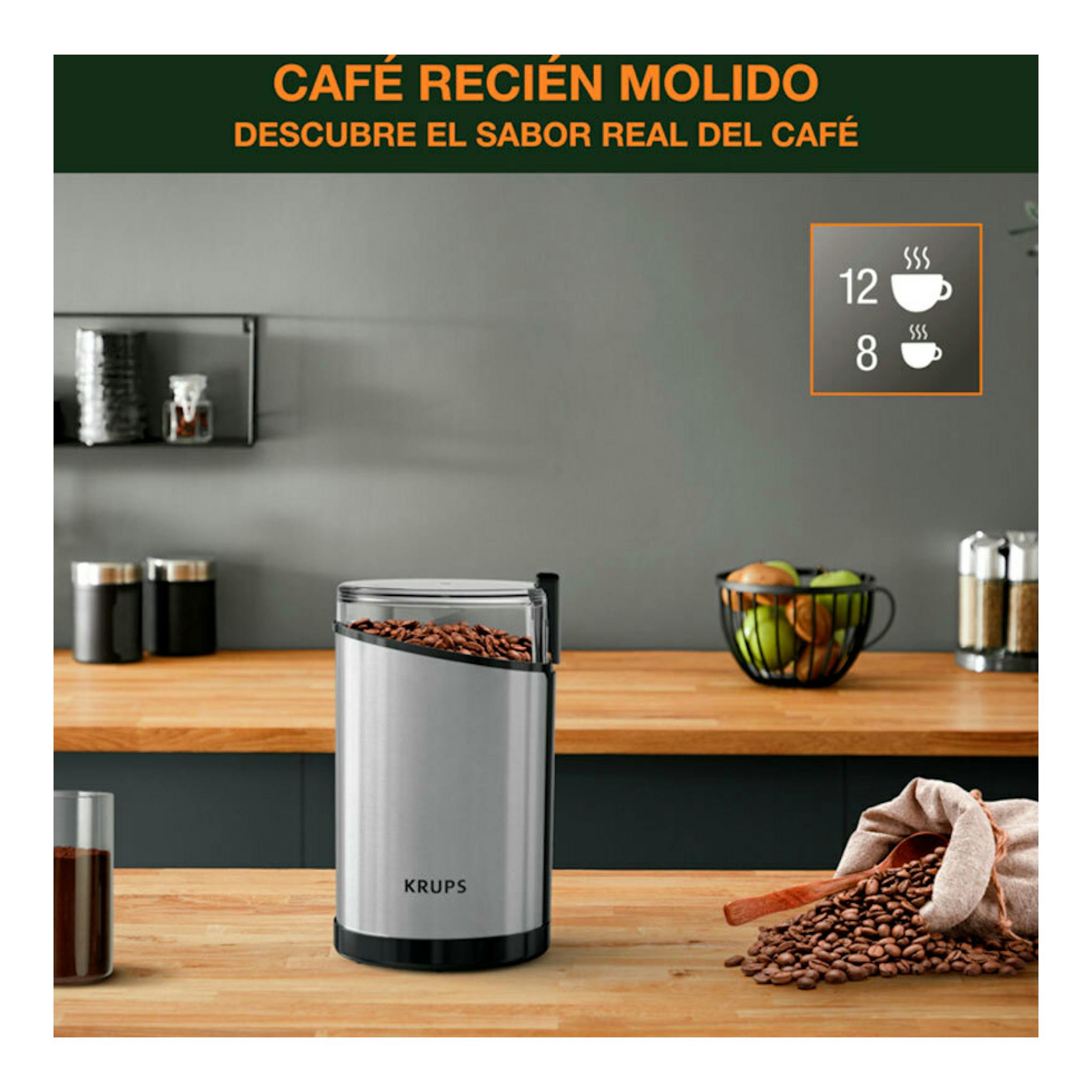 Molinillo de café Krups GX204D10, vista frontal, cuerpo plateado y negro, sobre encimera de madera con granos.