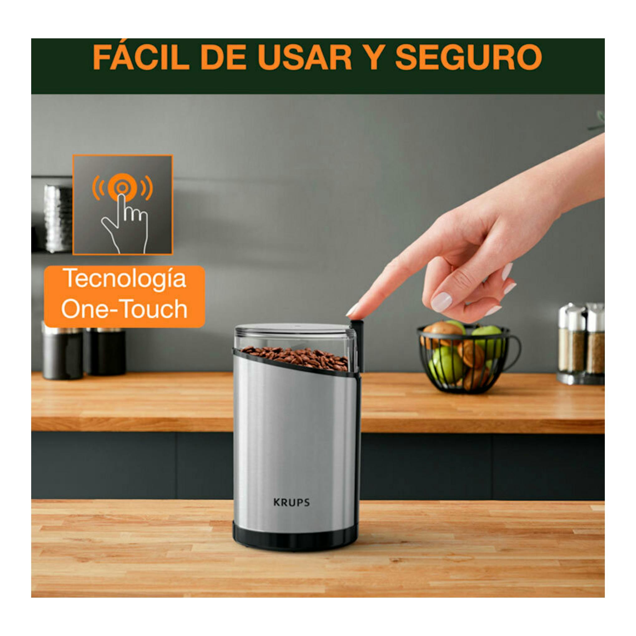 Molinillo de café Krups GX204D10 plateado y negro, vista frontal, con granos de café en la parte superior.