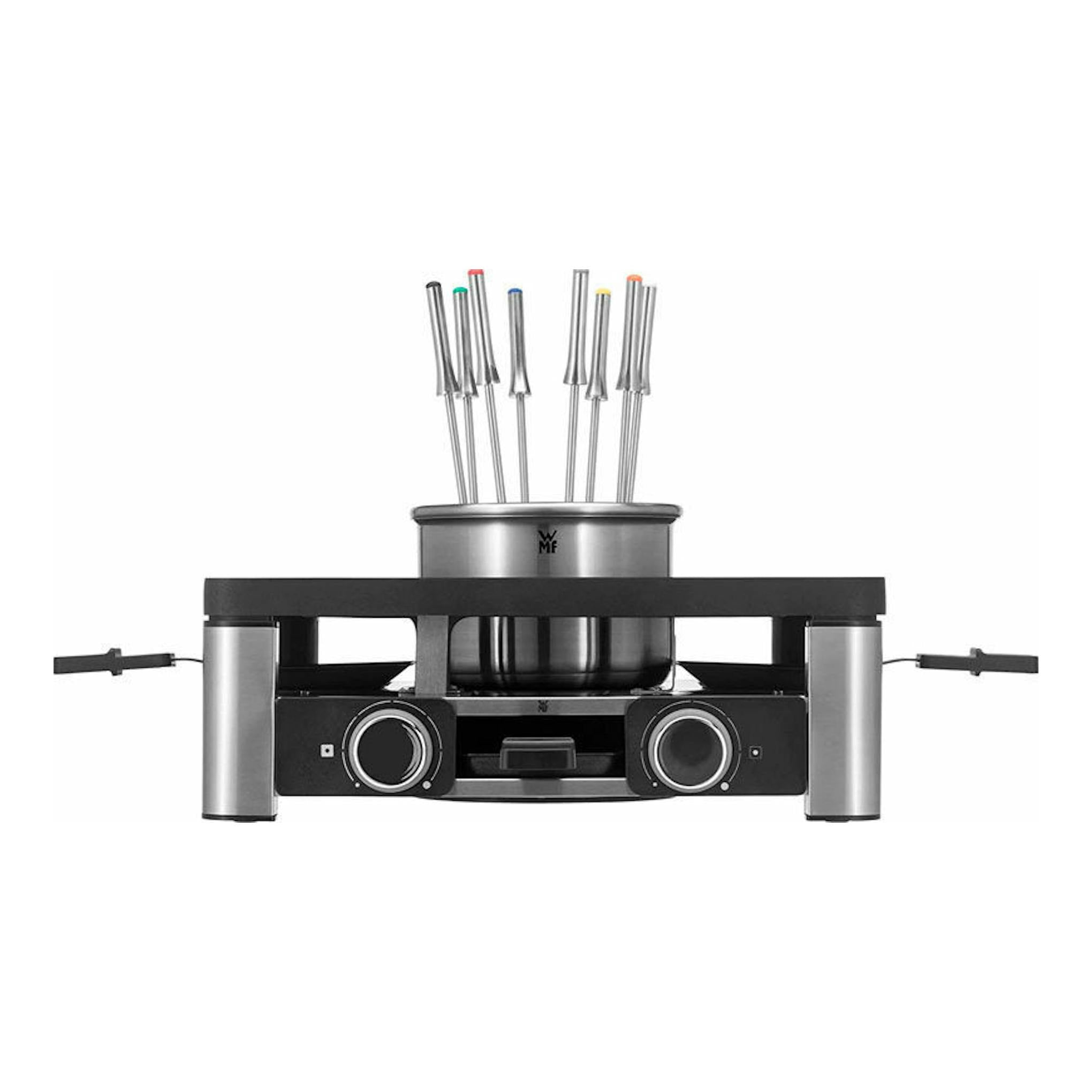 Parrilla grill WMF Gourmet negra y acero inoxidable, vista frontal, con olla y tenedores en la parte superior.