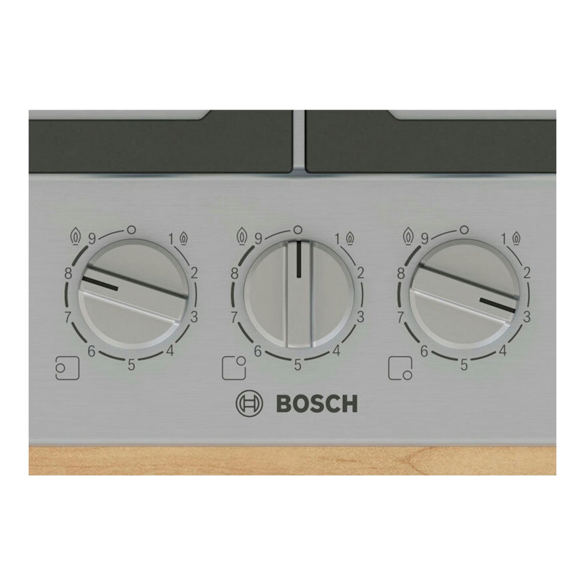 Placa de gas Bosch PCC6A5I90 de acero inoxidable, vista frontal con tres mandos circulares.