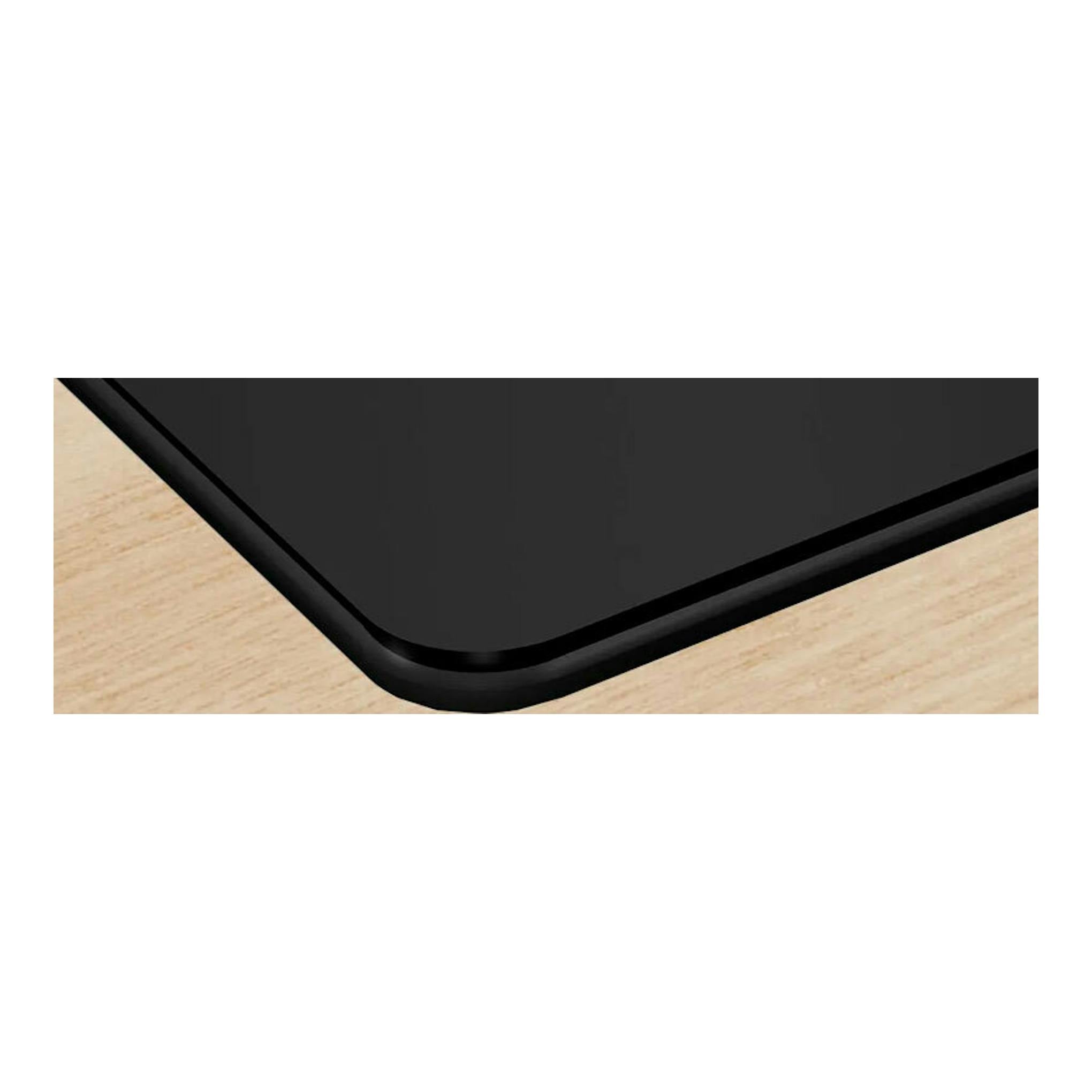 Placa de inducción Bosch PVS811B16E negra, vista en primer plano del borde sobre encimera de madera.