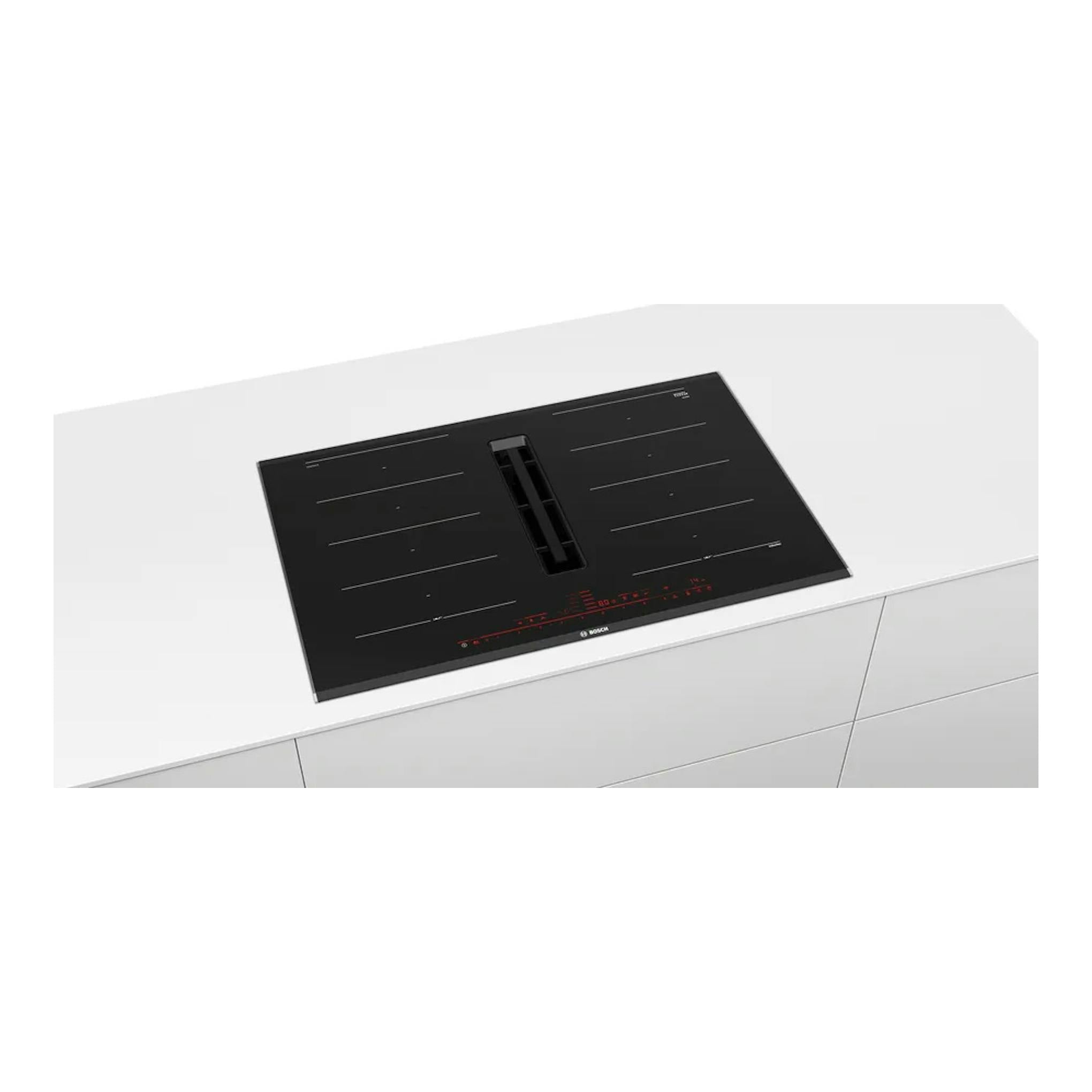 Placa de inducción Bosch PXX875D57E negra con extractor integrado, vista en perspectiva sobre encimera blanca.