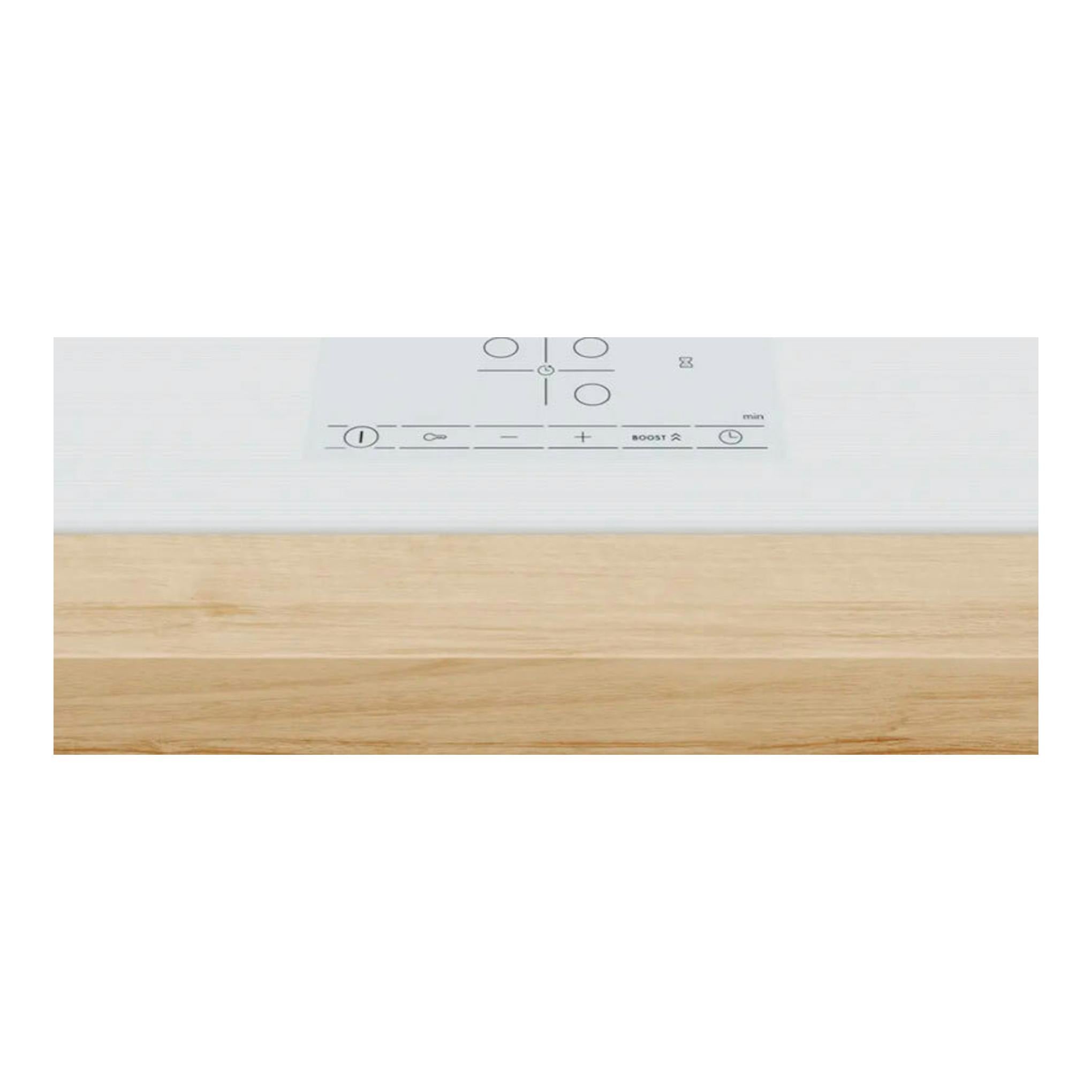 Placa de inducción Bosch PID612BB1E blanca, vista parcial superior con mandos táctiles y encimera de madera.