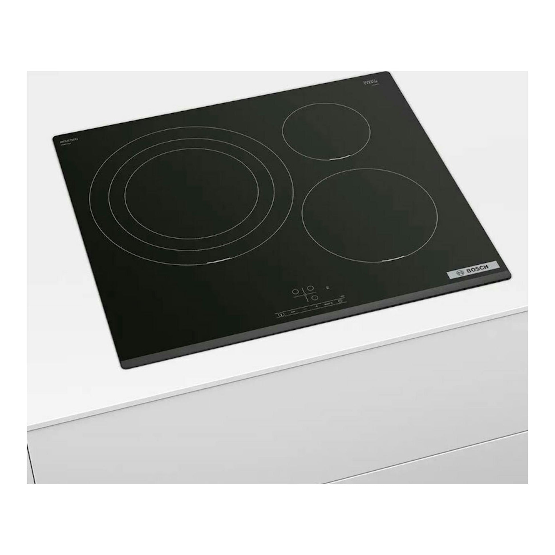 Placa de inducción Bosch PID631BB5E negra, vista en ángulo sobre encimera blanca.