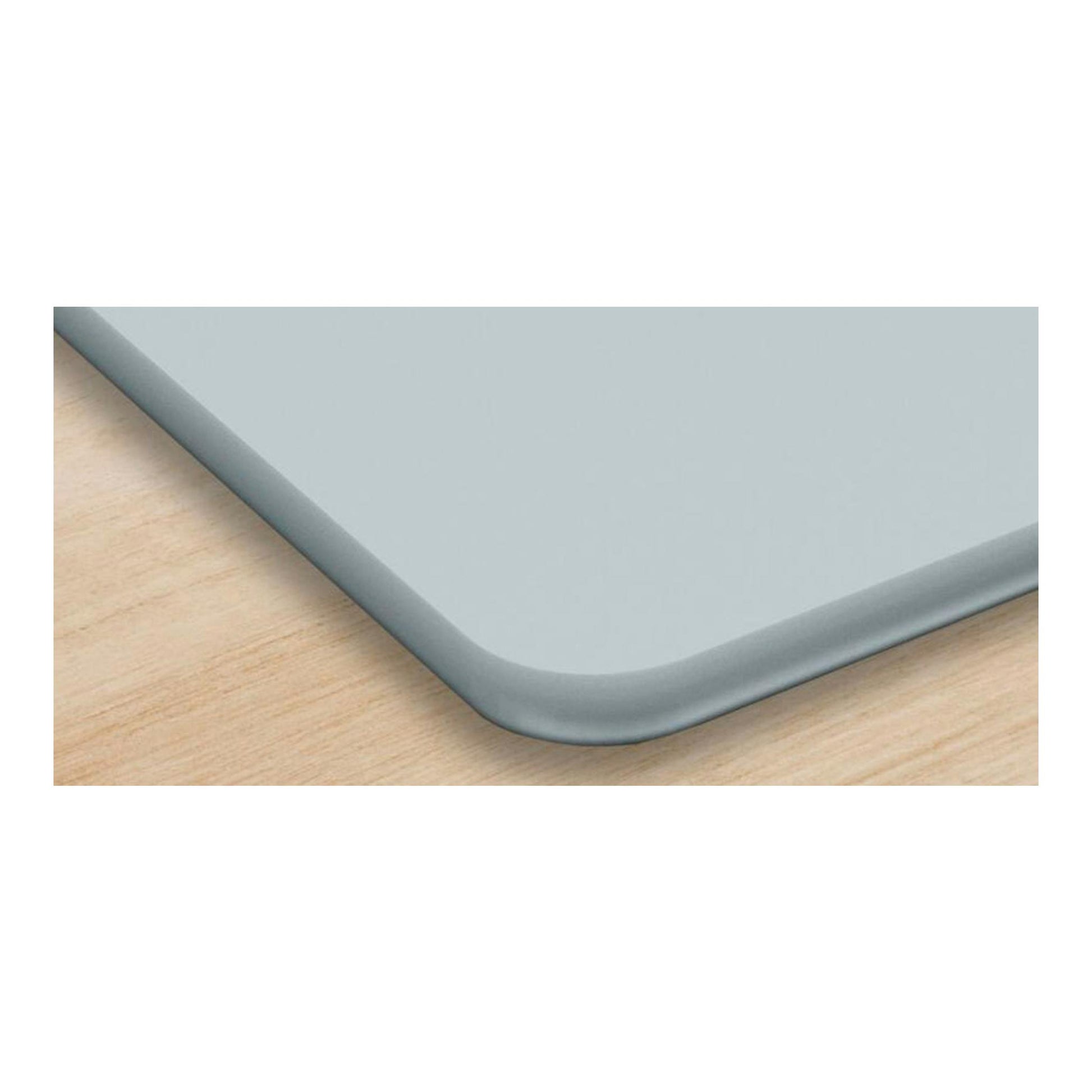 Placa de inducción Bosch PIF612BB1E, vista en primer plano de una esquina gris sobre superficie de madera.