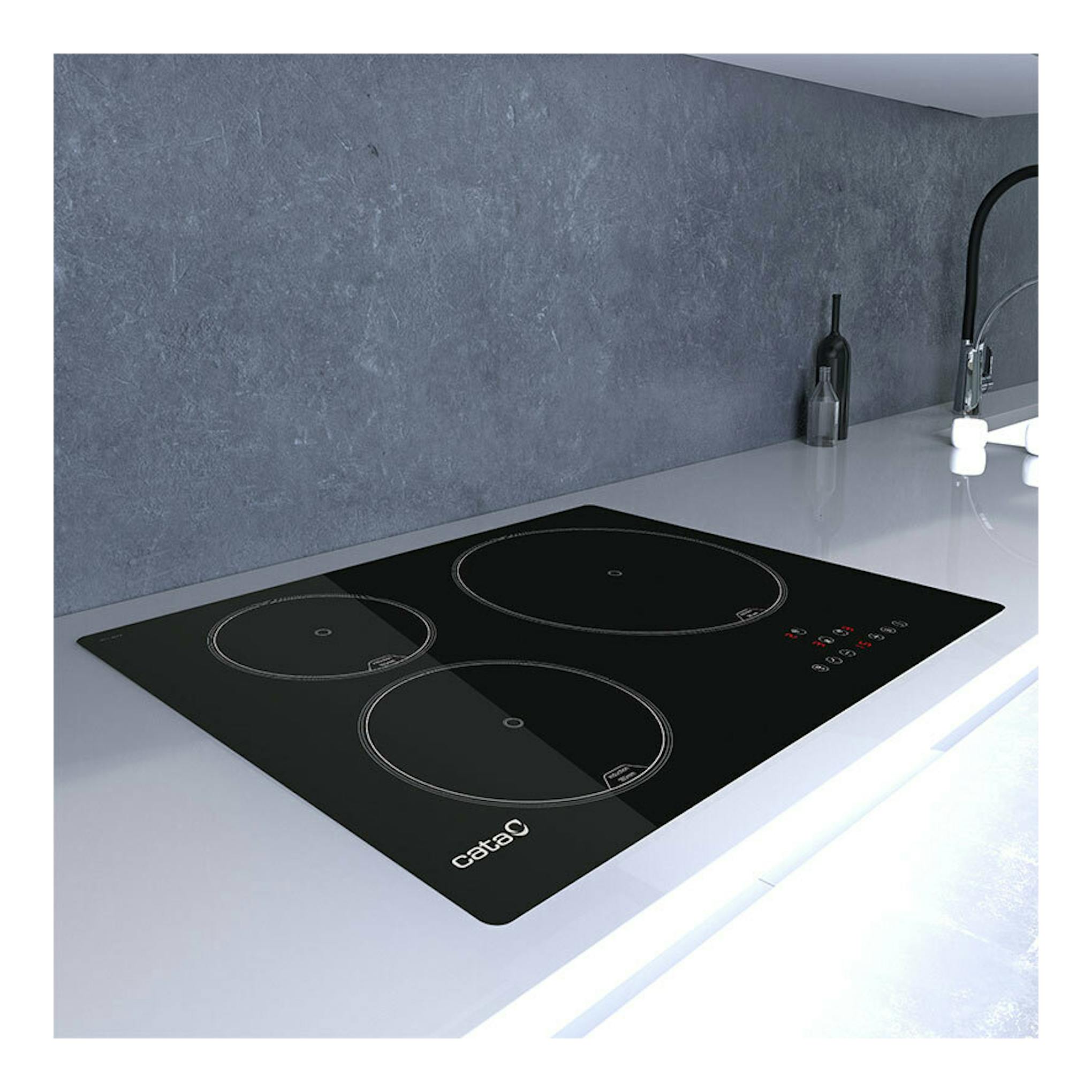 Placa de inducción Cata IB5003BK negra, vista en ángulo sobre encimera, con tres zonas de cocción.