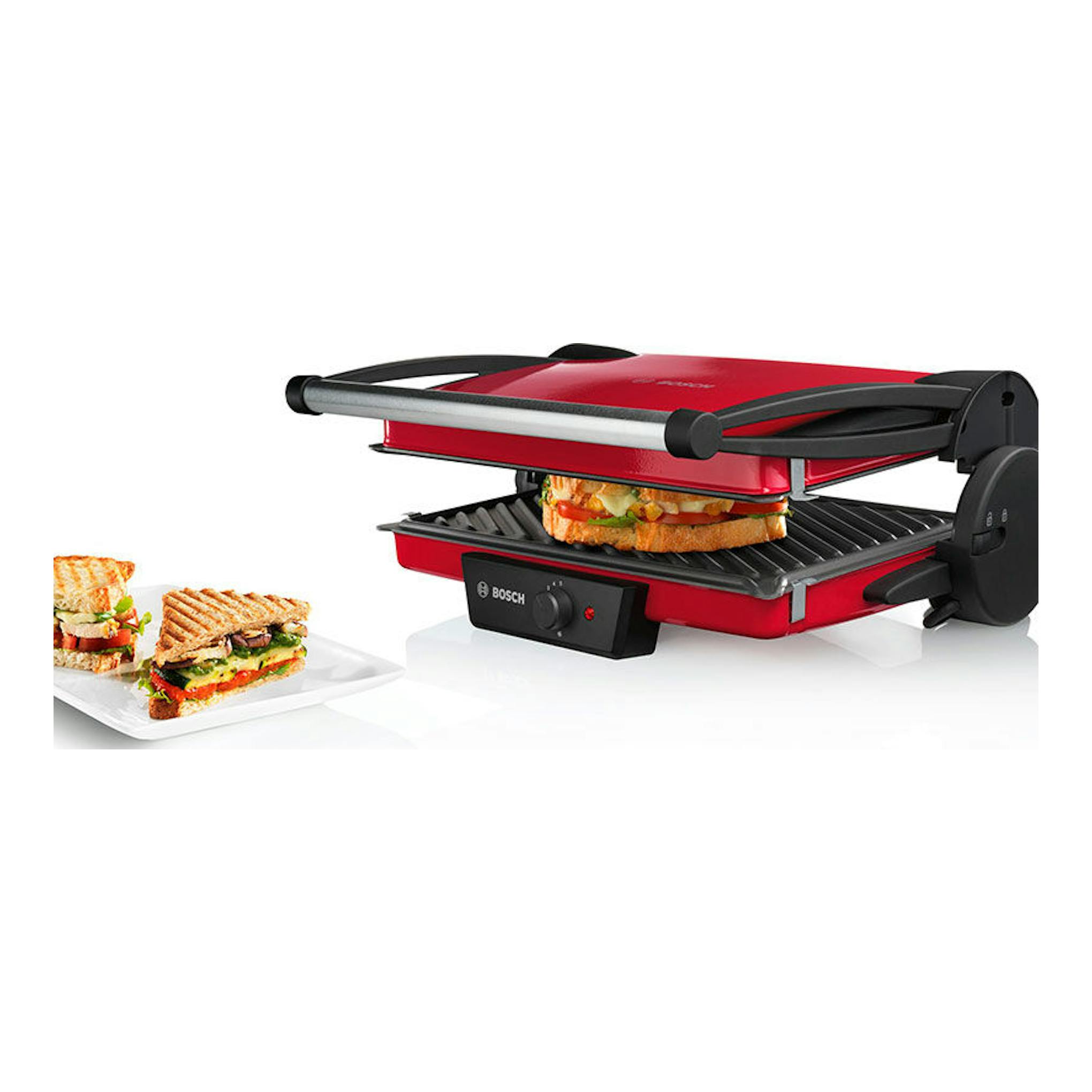Plancha grill Bosch TFB4402V roja y negra, abierta, con sándwiches tostados y uno en la parrilla.