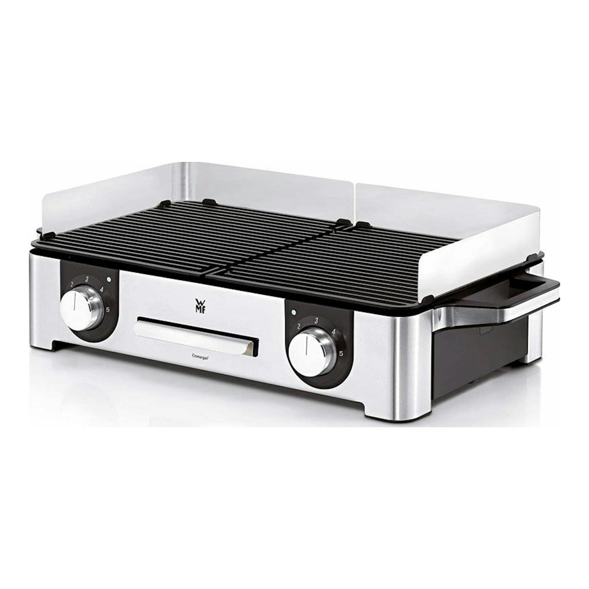 Plancha grill eléctrica WMF LONO, vista frontal en ángulo, acero inoxidable y rejilla negra.