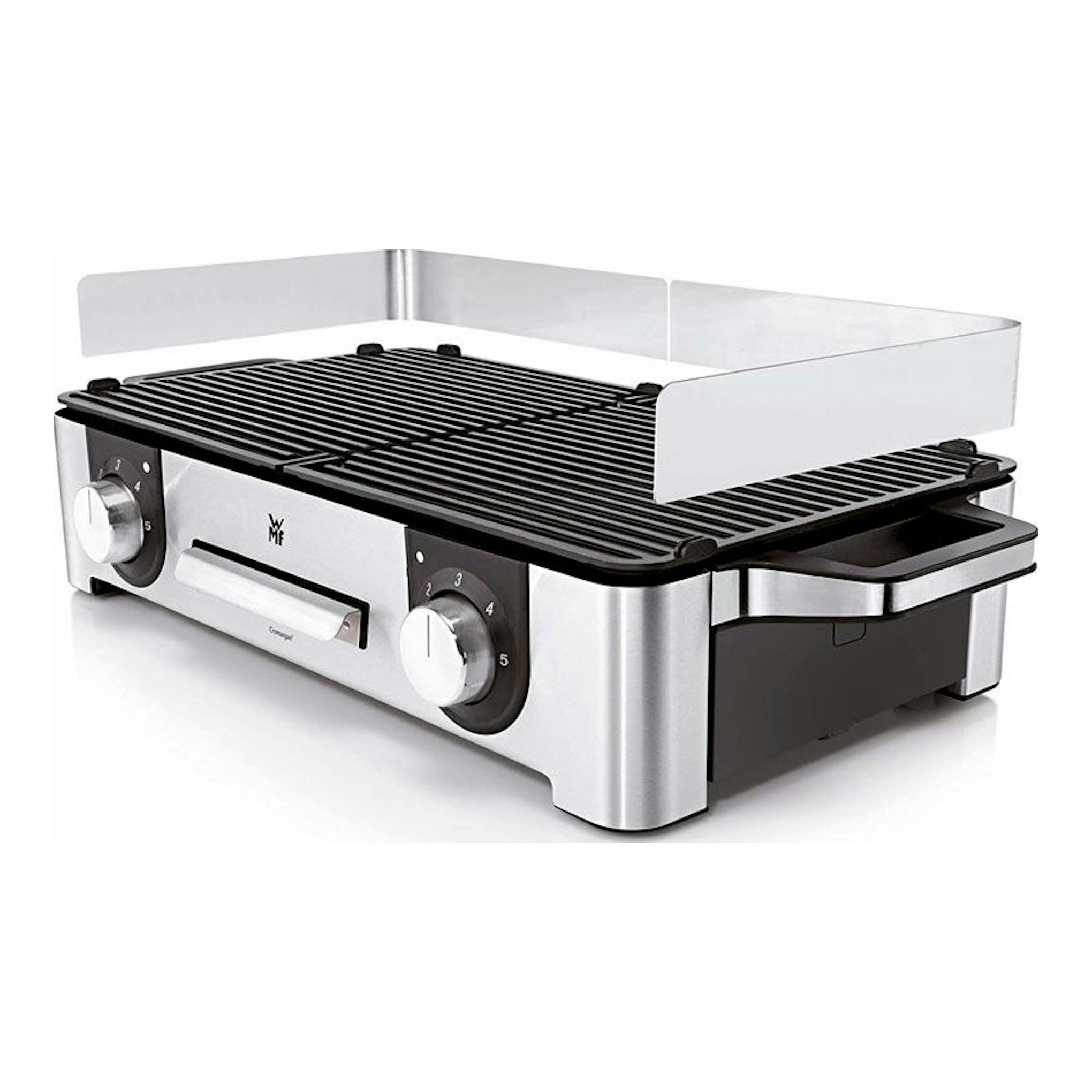 Plancha grill eléctrica WMF LONO Master Grill, vista 3/4, acero inoxidable y negro, con mandos frontales.