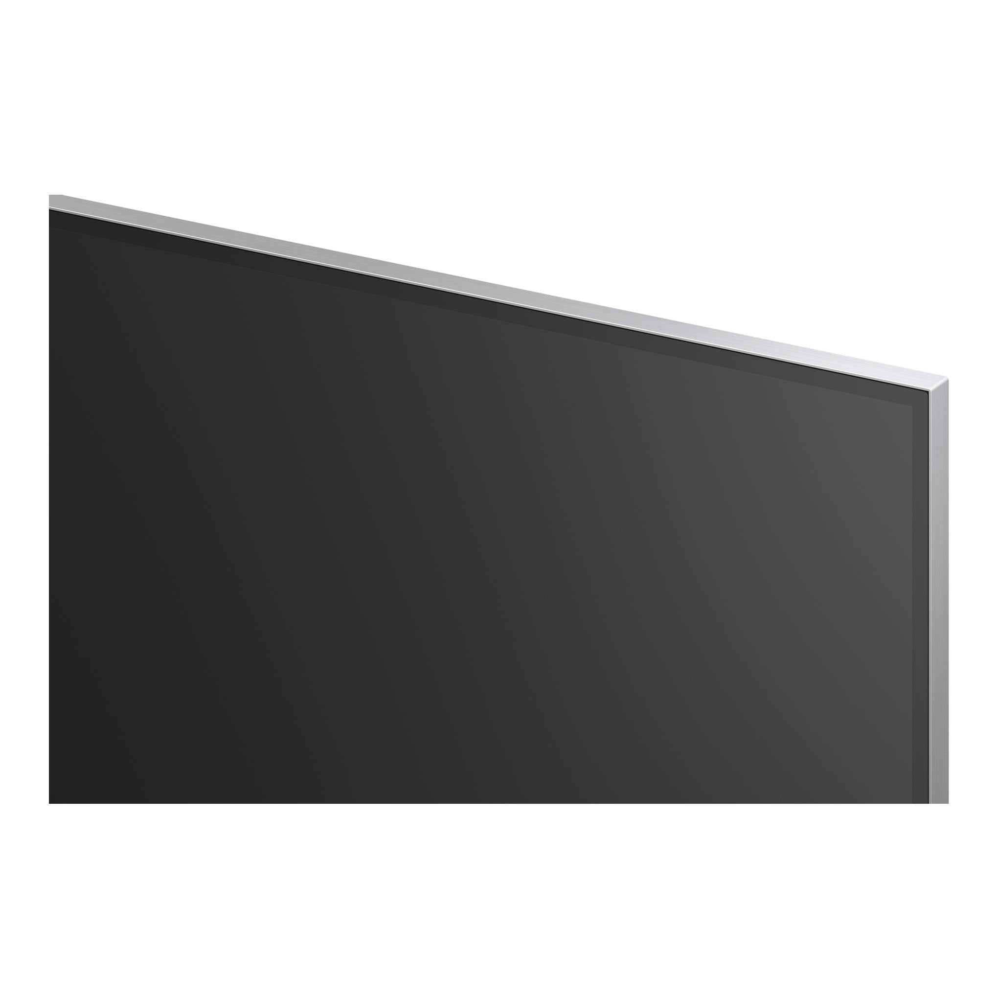 TV LG OLED65G64LW.AEU, vista parcial en ángulo, pantalla negra con marco plateado sobre fondo blanco.