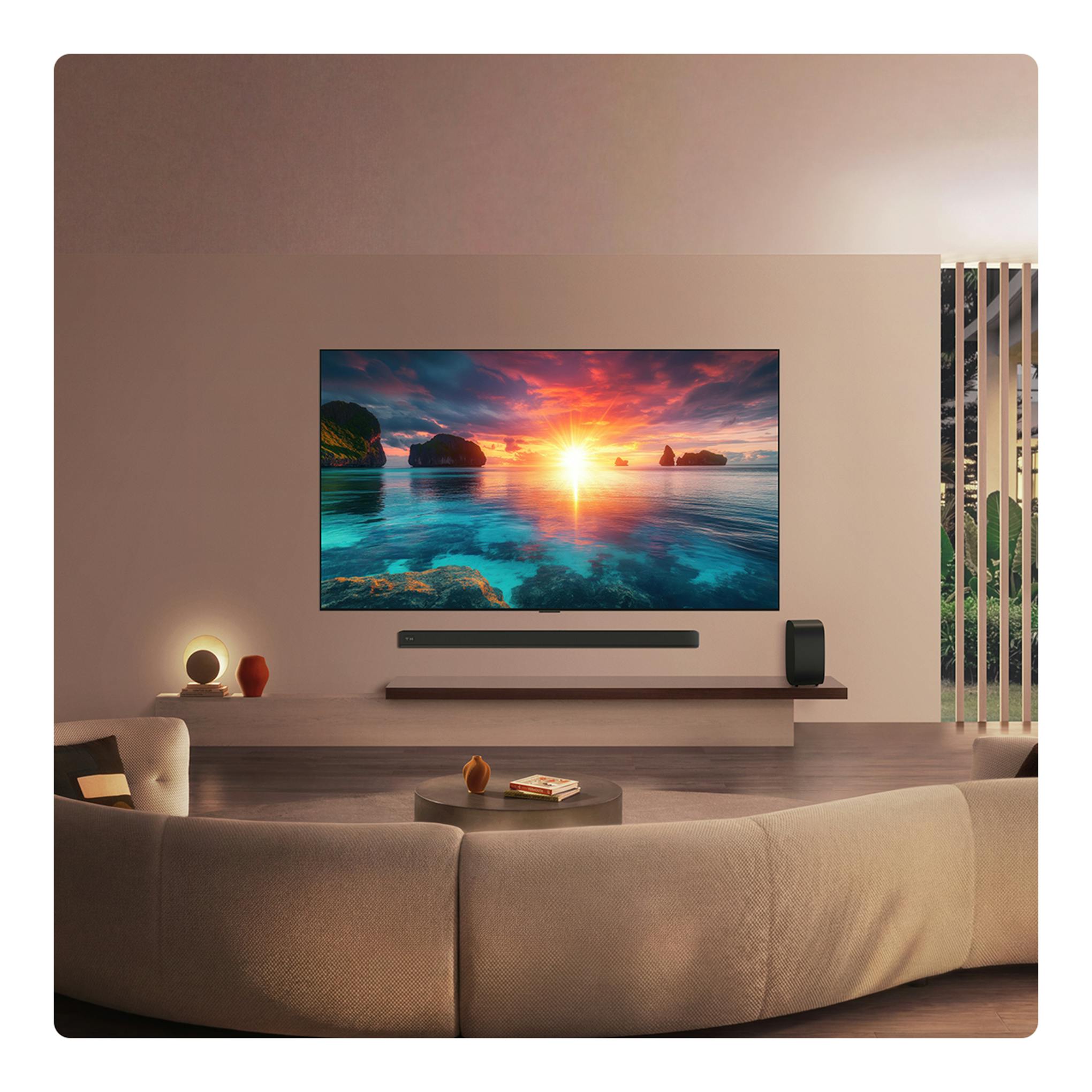 Televisor LG OLED97G64LW.AEU montado en pared, vista frontal, con imagen de atardecer en pantalla.